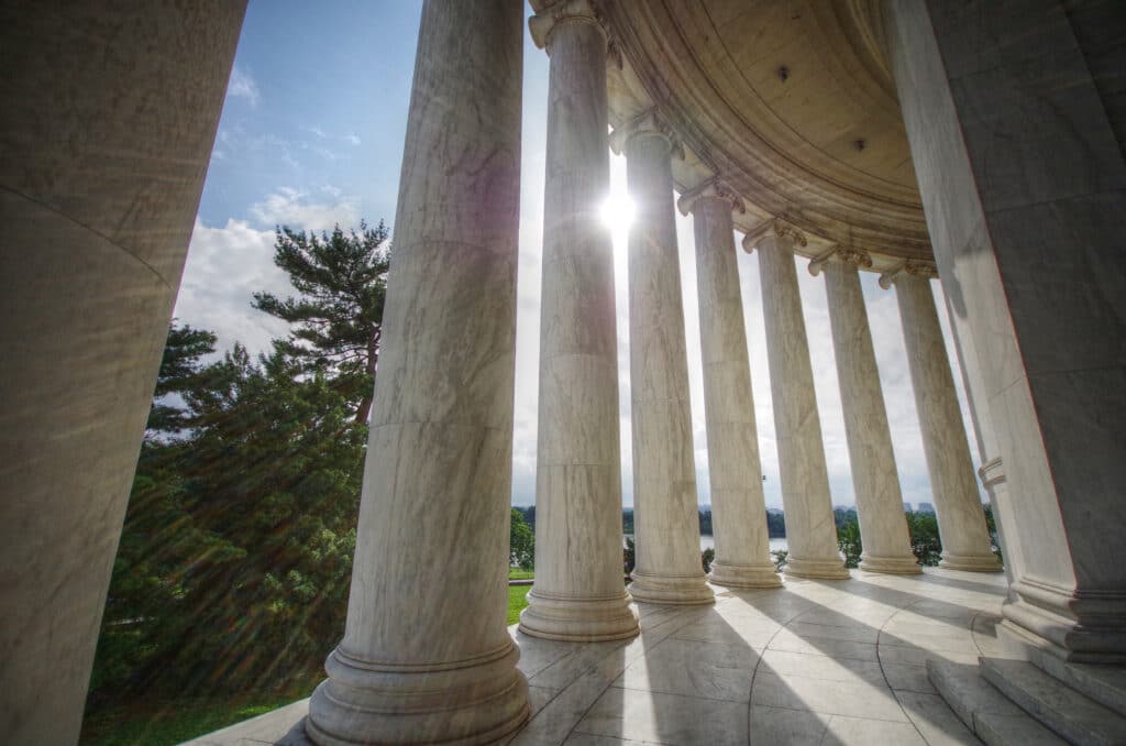 Sun Shining Through Columns At The Jefferson Memorial In Washington