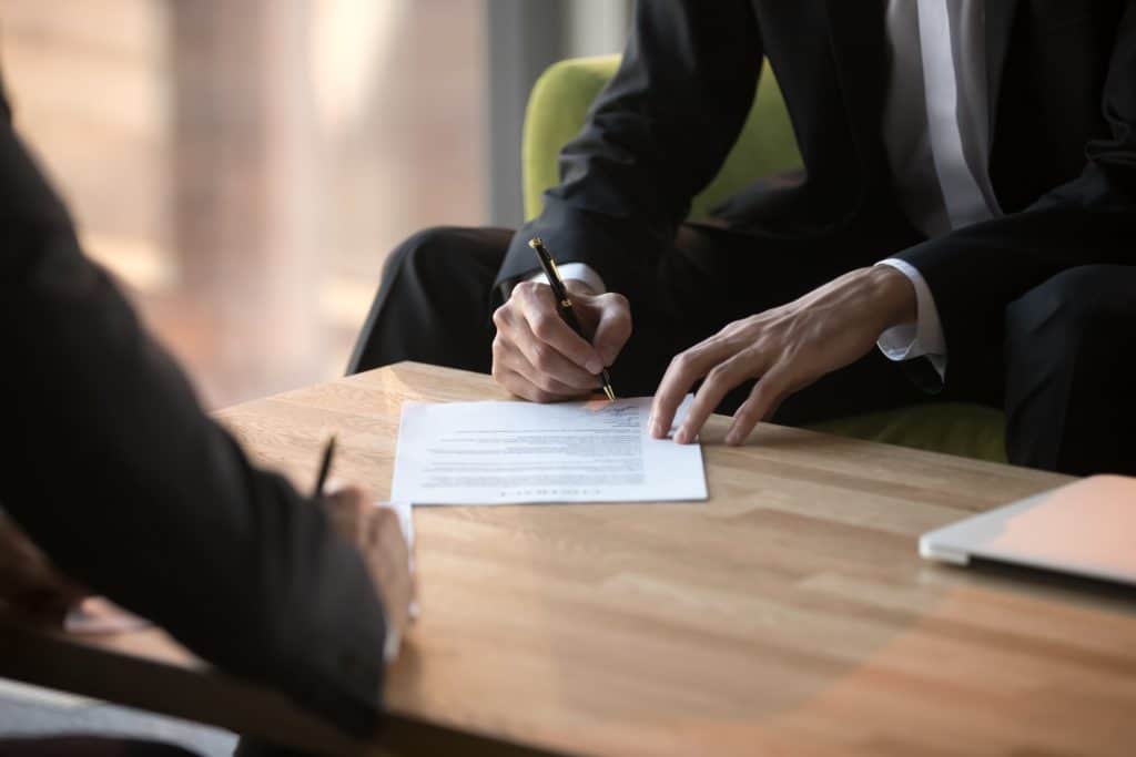 Person Signing A Paper